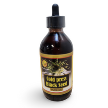 Bottle of cold press black seed pure oil with a dropper on a white background