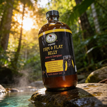 Bottle of 'Firm & Flat Belly' on a rock with a forest background
