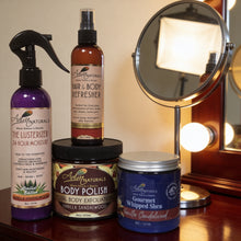 Collection of Adiva Naturals Vanilla Sandalwood beauty products on a wooden surface with a mirror in the background.