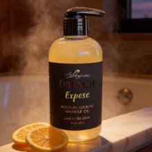 Bottle of Drench Expose skincare shower oil on a marble ledge with steam in the background